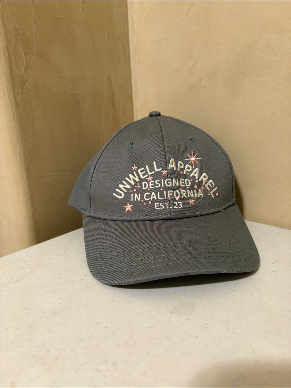 Unwell Apparel Gray Baseball Cap with Pink Star Accents